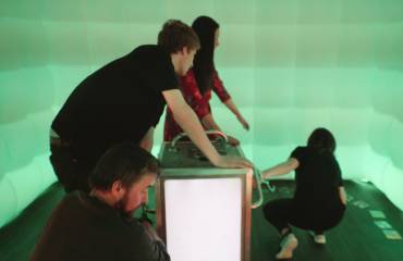 Teams figuring out puzzles in one of our inflatable Mobile Escape Rooms